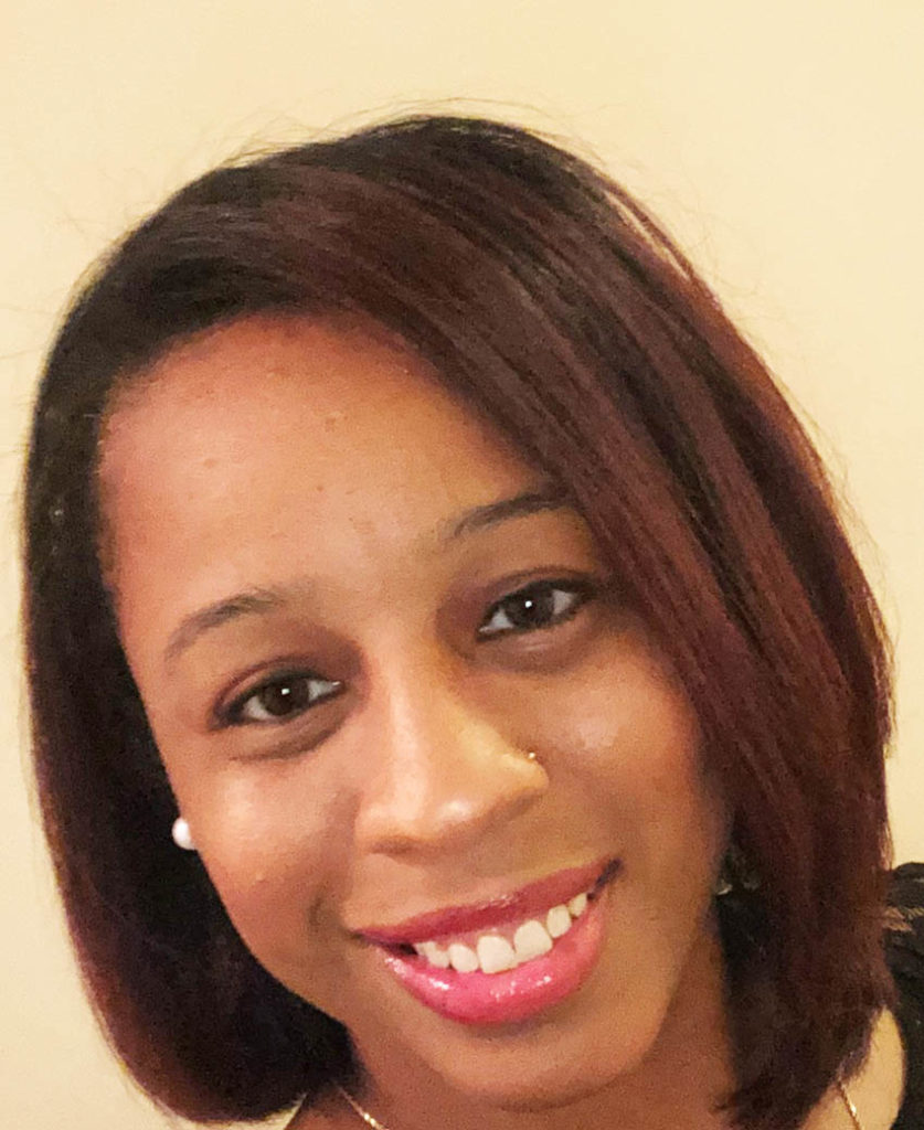 A person who is smiling and looking at the camera

Description automatically generated